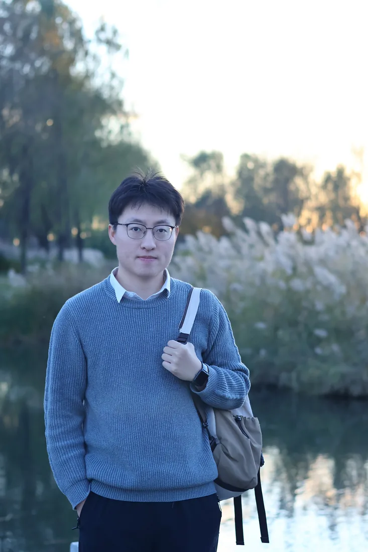A portrait beside a lake and trees in Beijing.