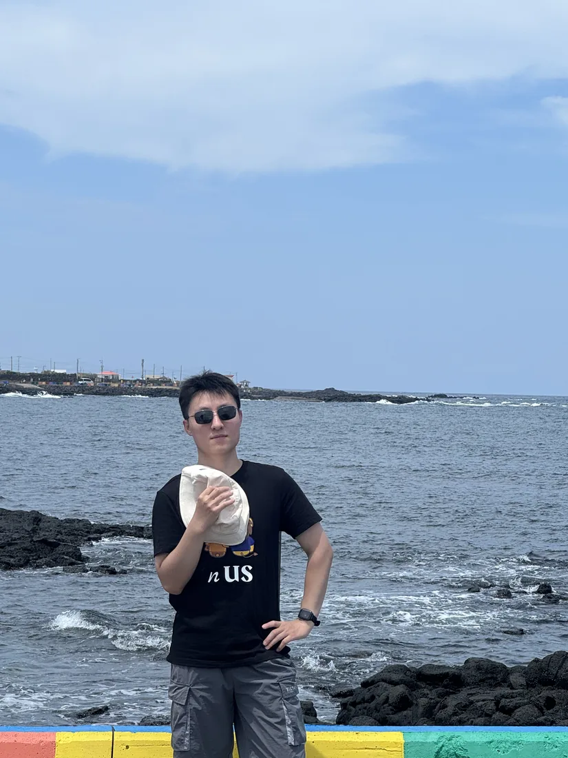 Standing beside the coast on Jeju Island.