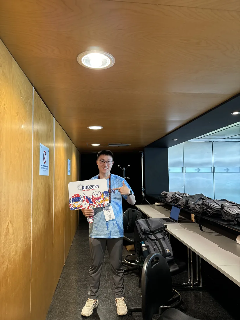 Holding conference materials at the KDD 2024 venue.